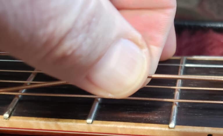 Loosen acoustic guitar string
