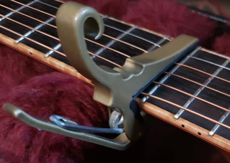 Acoustic guitar capo at tenth fret during restringing