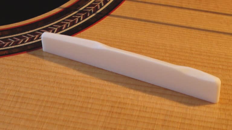 Acoustic Guitar Bone Saddle Resting on Guitar Top